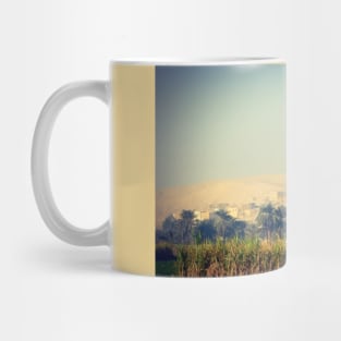 hot air balloon over a traditional village in the Egyptian countryside Mug